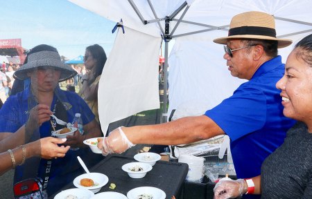 Lemoore's Sunny Law of Sushi Table, hands out samples of his cuisine.